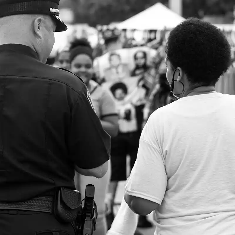Police officer chatting with woman